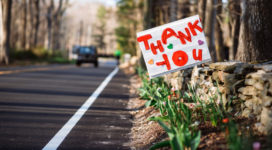 road with flowers and thank you sign